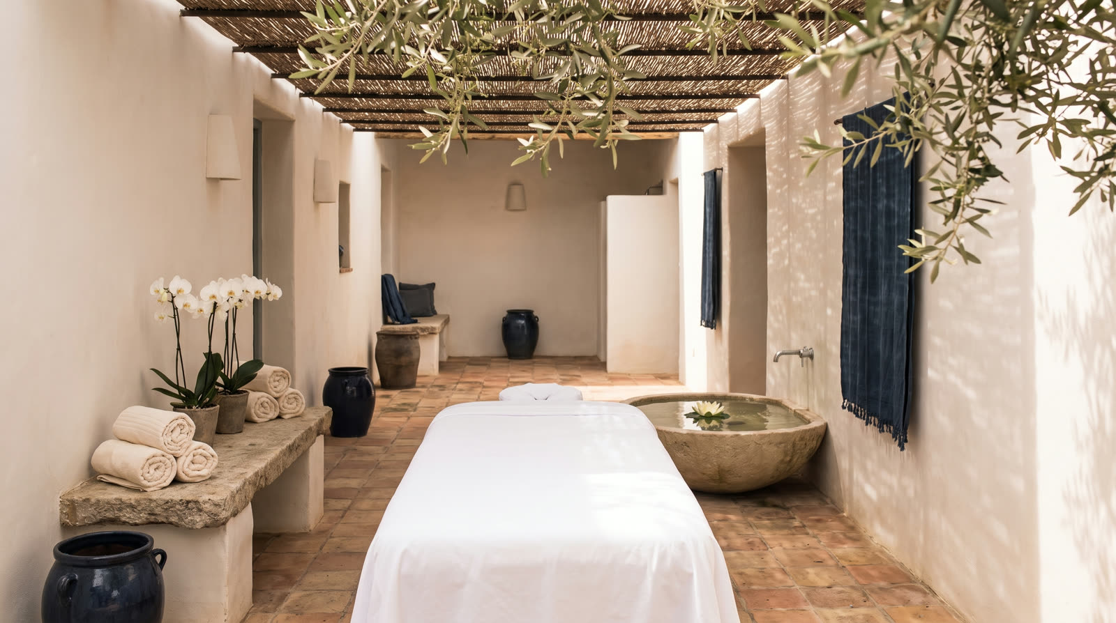 Massage table in a shaded villa courtyard